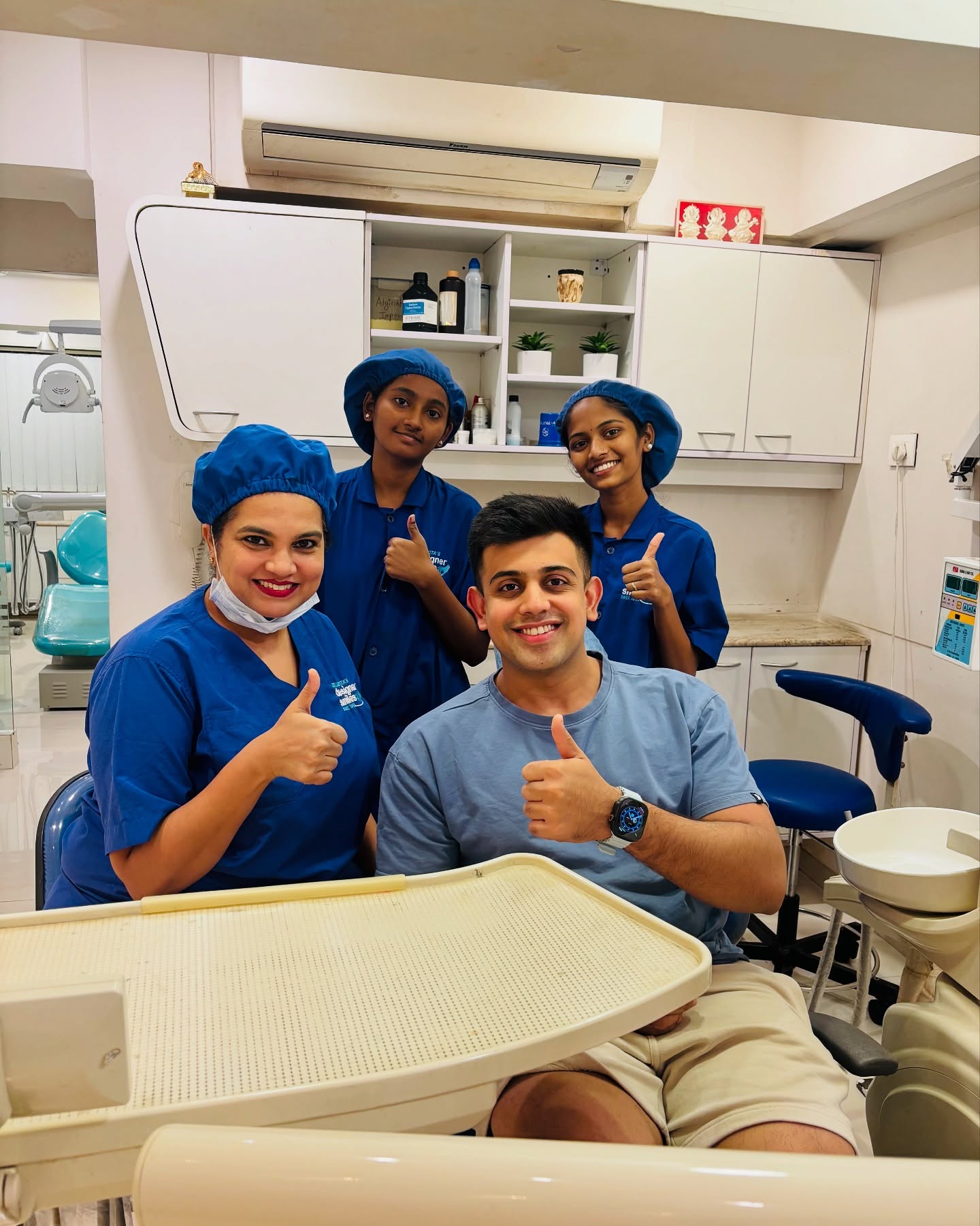Patient and Designer Smiles team thumbs up after treatment